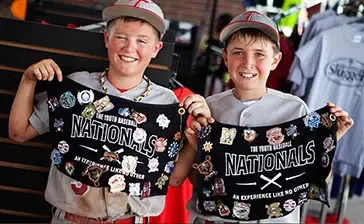 two boys showing their baseball trading pins
