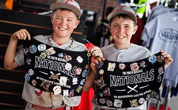 two boys showing their baseball trading pins